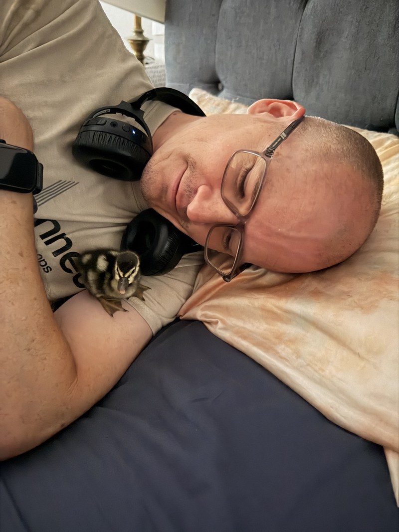 Tony resting beside one of the young ducklings during the period when
the ducks lived closely with the family.